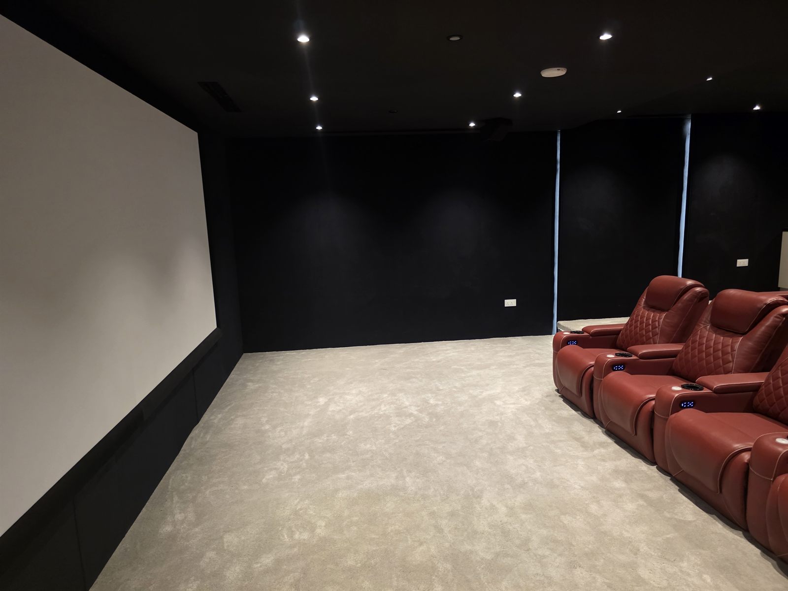 Society House home cinema, Burj Khalifa District: the screen wall and reclining seats