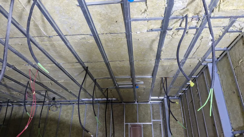 Mineral wool packed between the wall and ceiling framing