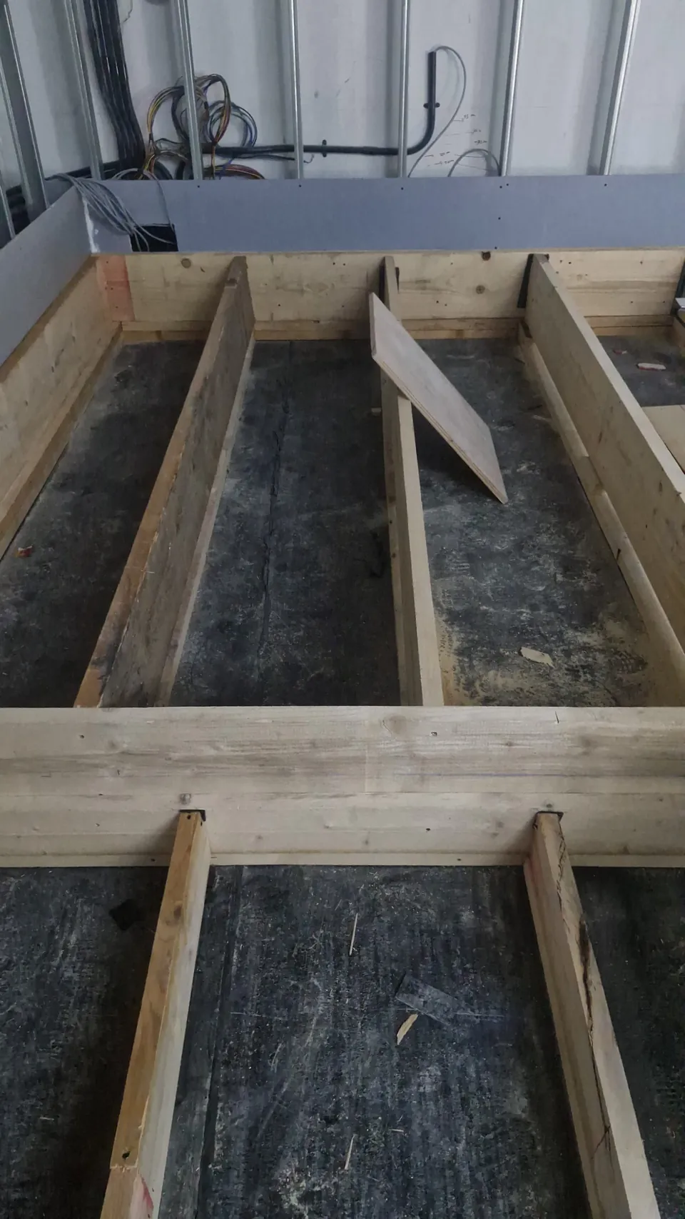 Timber joists of the stepped seating riser under construction