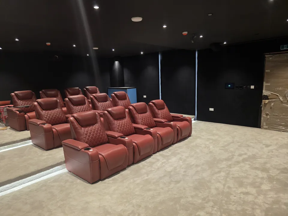 Three rows of recliners on the riser, seen from the side