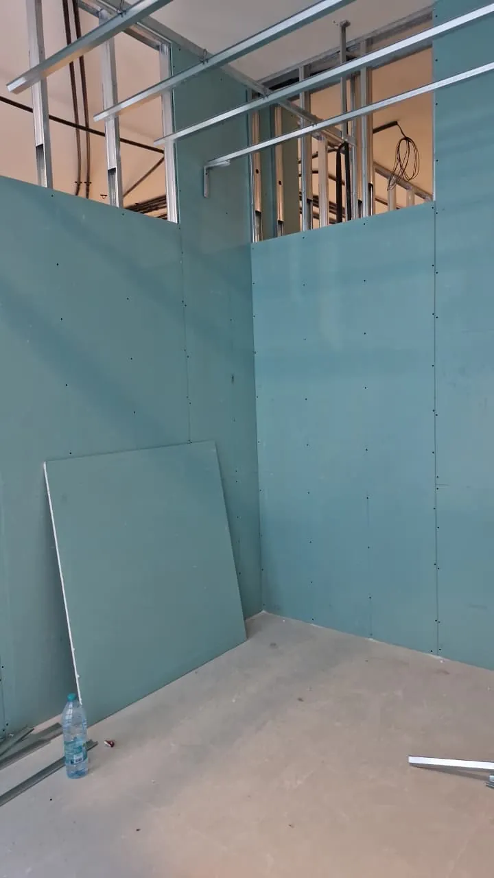 Sound-rated gypsum boards going up on the steel framing