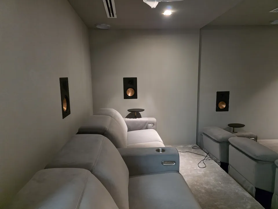 In-wall speakers on the side wall beside the recliners