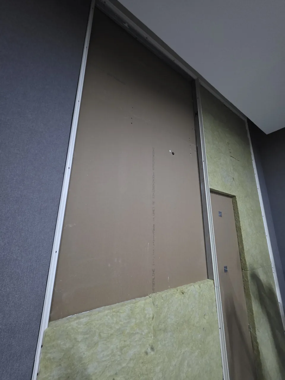 The window opening being closed with gypsum board and rockwool insulation