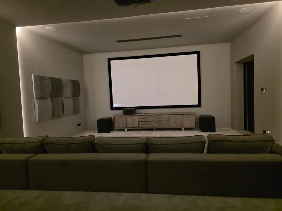 The framed screen and treated side wall seen from the back row